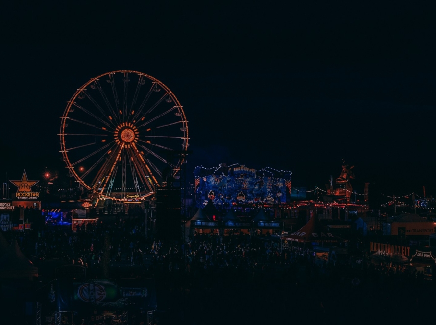 lighted Ferris wheel beside building